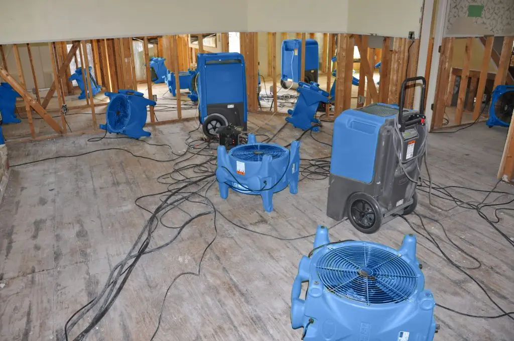 Air movers drying a gutted San Diego room after major water damage